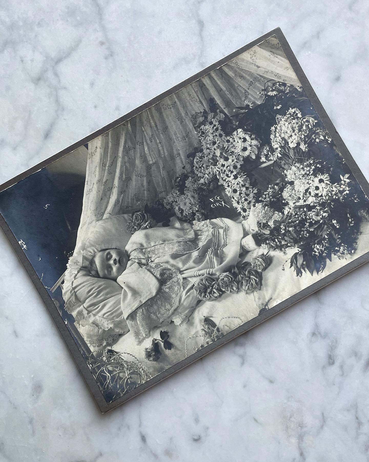 Post Mortem Photo of Baby Surrounded by Flowers