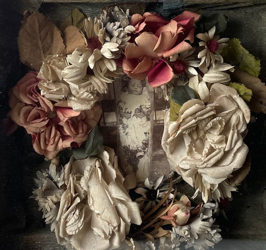 Victorian shadow box containing a muslin flower wreath and a cabinet card photo of a deceased infant in their coffin