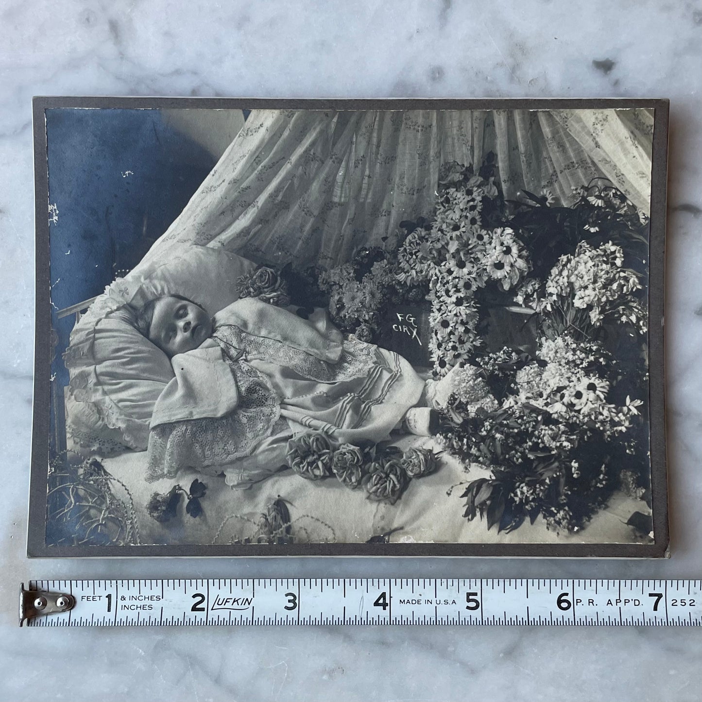 Post Mortem Photo of Baby Surrounded by Flowers